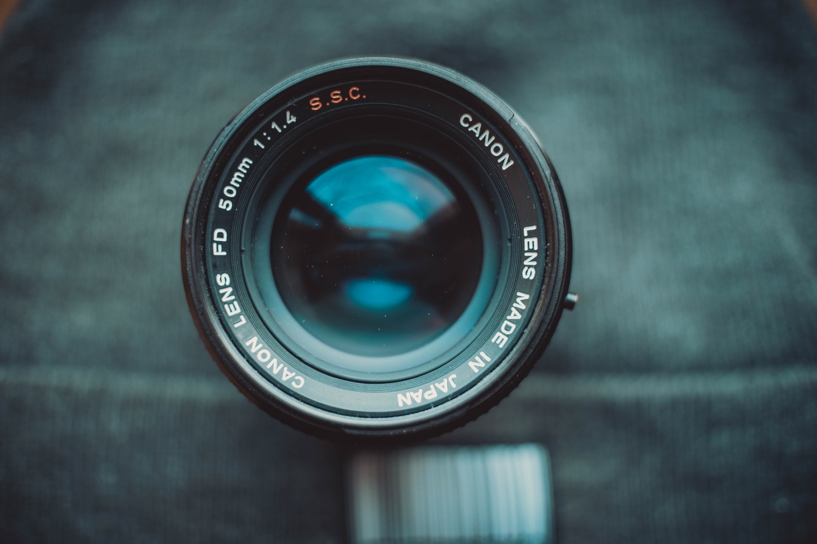 black camera lens on gray textile